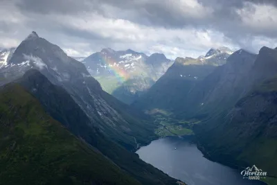 The iconic peak of Slogen on the left and the village of Øye at the end of the Norangsfjord The iconic peak of Slogen on the left and the village of Øye at the end of the Norangsfjord