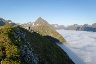 Egilbu shelter located at the summit of Klokksegga, Slogen on the left and sea of clouds over the Hjørundfjord Egilbu shelter located at the summit of Klokksegga, Slogen on the left and sea of clouds over the Hjørundfjord