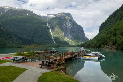 Lac Lovatnet and Ramnefjellfossen waterfall from the Kjenndalstova café Lac Lovatnet and Ramnefjellfossen waterfall from the Kjenndalstova café