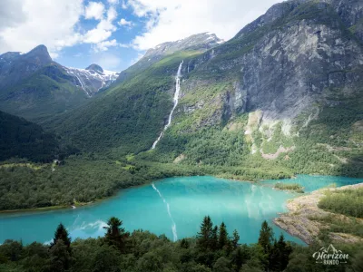 Lake Lovatnet and Ramnefjellfossen waterfall from the road Lake Lovatnet and Ramnefjellfossen waterfall from the road