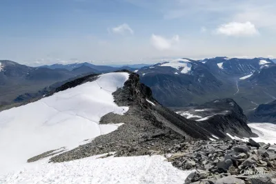 Climbing between small snowfields and scree slopes Climbing between small snowfields and scree slopes