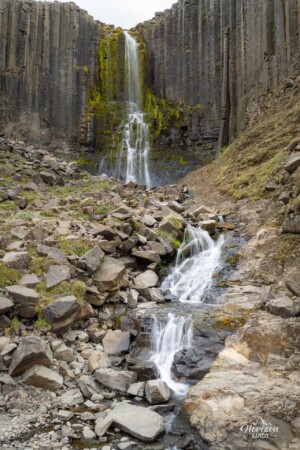 Waterfall along the path Waterfall along Stuðlagil canyon