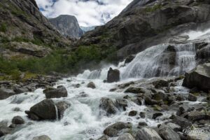 Waterfall at the end of the trail, Brenndal glacier in the distance Waterfall at the end of the trail, Brenndal glacier in the distance