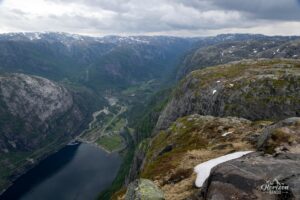 The vertiginous walls of Kjerag, village of Lysebotn below The vertiginous walls of Kjerag, village of Lysebotn below